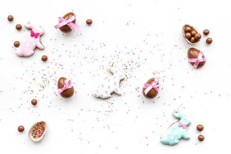 Celebrate Easter. Modern signs of Easter. Chocolate Easter eggs and Easter bunny cookies. White background top view.の写真素材