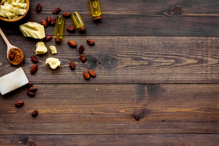 Homemade soap with cocoa butter. Cosmetics with natural ingredient. Dark wooden background top view.
