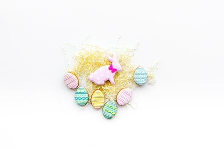 Sweets, pastry for Easter table. Easter eggs and Easter bunny concept. White background top view.