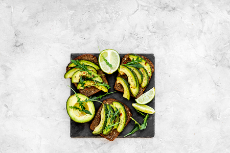 Snacks with avocado. Avocado toast with rye bread on grey background top view.の写真素材