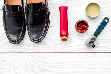 Clean shoes. Set of shoe care products. Polish, brushes, wax. White background top view copy spaceの写真素材