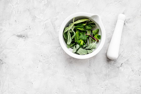 Phytotherapy. Herbs in mortar bowl on white background top view.の写真素材