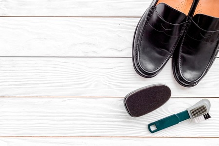 Shoe care products. White wooden background top view.の写真素材