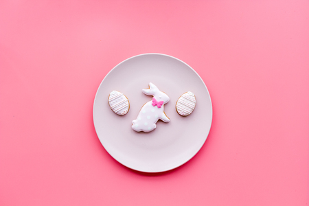 Sweets, pastry for Easter table. Easter eggs and Easter bunny concept. Pink background top view.の写真素材