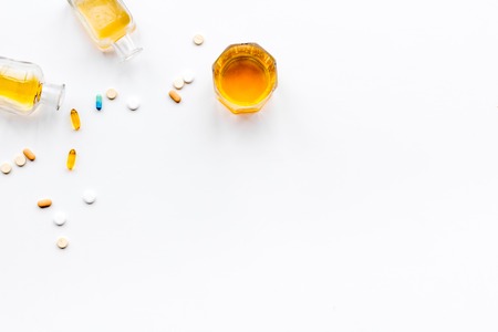 Alocohol abuse and alcoholism treatment concept. Glasses, bottles and medcine pills on white background top view.の写真素材