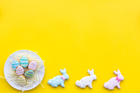 Easter gingerbread and cookies. Easter eggs and Easter bunny concept. Yellow background top view.の写真素材