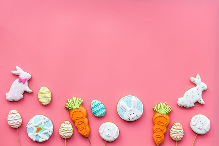 Easter bunny and easter eggs cookies. Easter symbols and traditions. Pink background top view.