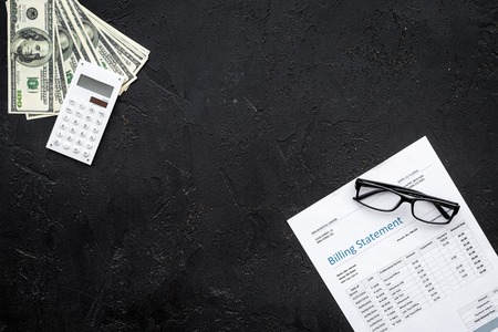 Paying bills. Billing statement near calculator, money, glasses on black background top view copy...