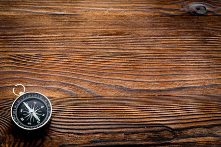 Compass on dark wooden background top view copy space.の写真素材