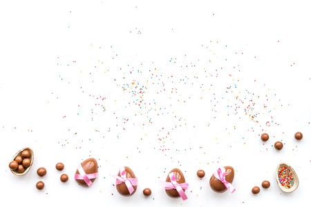 Chocolate Easter eggs as little gift. White background top view.