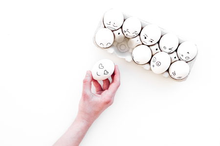 Basic emotions concept. Faces drawn on eggs. Happy, smile, sad, angry, in love. White background top view copy spaceの写真素材