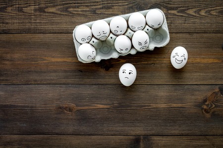 Emotions in communication at social media. Faces drawn on eggs. Happy, smile, sad, angry, in love, saticfied, laughing. Dark wooden background top view copy spaceの写真素材