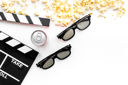 Cinema background. Film watcing. Glasses, popcorn and clapperboard on white background top view.の写真素材