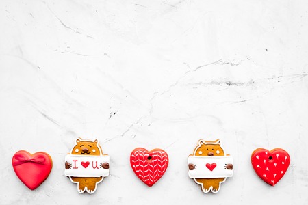 Sweet gift for St Valentine's Day. Heart shaped gingerbread on light grey background top view.の写真素材