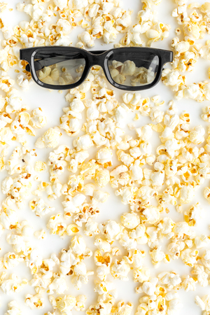 Cinema accessories. Cinema glasses and popcorn on white background top view.の写真素材