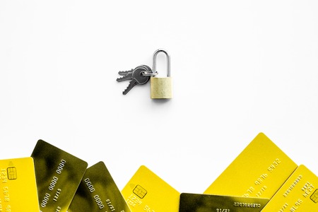 Electronic payments protection. Bank cards near lock and keys on white background top view.の写真素材