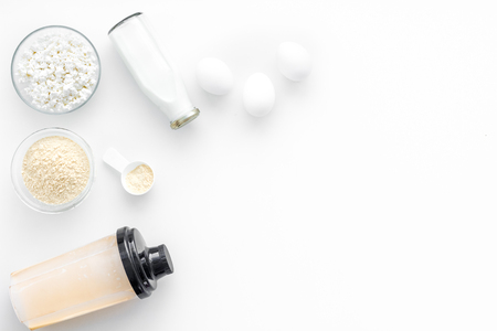 Sports nutrition. Scoop of protein near shaker on white background top view.の写真素材