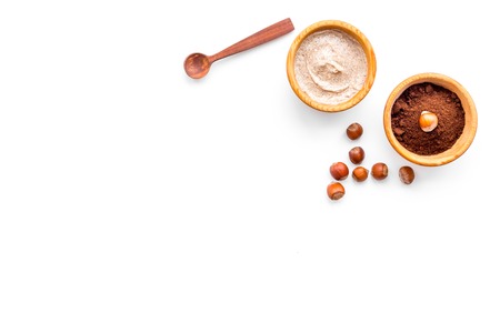 Natural cosmetics for skin care. Body scrub with hazelnut. White background top view copy spaceの写真素材