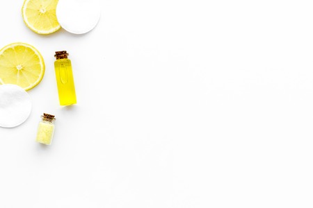 Natural organic cosmetics with lemon. Lemon oil or lotion, spa salt in small bottles on white background top view.の写真素材