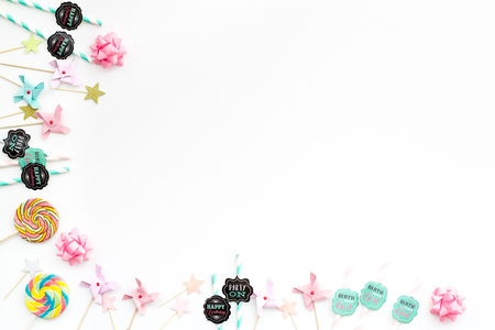 Birthday party background. Lollipop and decoration on white top view copy spaceの写真素材