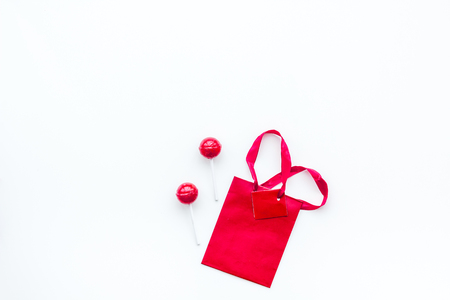 Gift concept. Sweets, paper bag for gift on white background top view.の写真素材