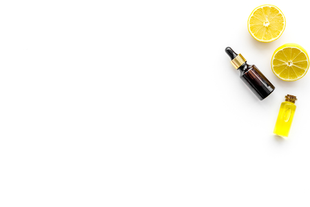 Skin care. Lemon oil, lemon lotion on white background top view.の写真素材