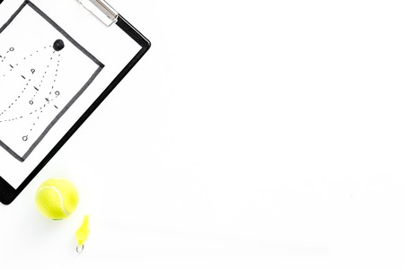 Sport coach concept. Pad with tactic plan of the match near whistle on white background top view.の写真素材