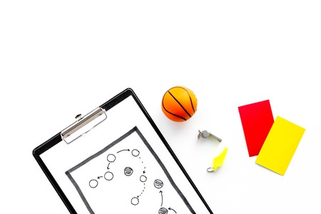 Sport judging concept. Referee. Tactic plan for game, basketball ball, red and yellow cards, whistle on white background top view copy spaceの写真素材