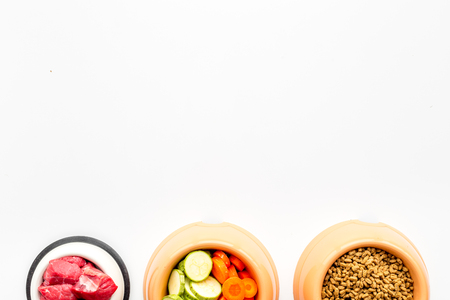 Ingredients for dry pet food. Meat and vegetables zucchini and carrot on white backgroud top view copy spaceの写真素材