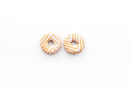 Unhealthy tasty sweets. Glazed donut on white background top view copy spaceの写真素材