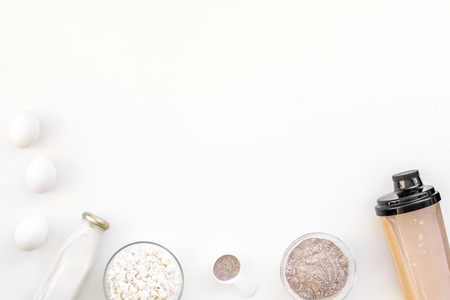sport diet protein nutrition with eggs and milk and fitness equipment on white background top view mock upの写真素材