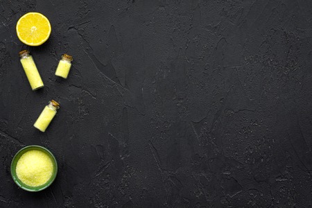 Natural cosmetics set with fresh lemon and organic oil on black background top view mock upの写真素材