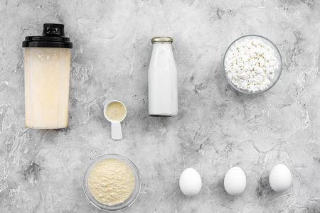 protein powder for fitness nutrition to start training and eggs and milk on gray background top view mock-upの写真素材
