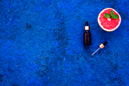 Homemade spa with grapefruit oil in natural cosmetic set fruit on blue background top view mock upの写真素材