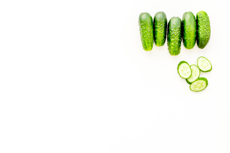 Greeny cocktail ingredients. Fitness smoothie. Cucumber on white background top view space for text.の写真素材