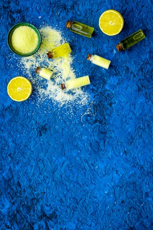 Organic cosmetic with lemon for homemade spa with salt and fresh fruit on blue background top view mock upの写真素材