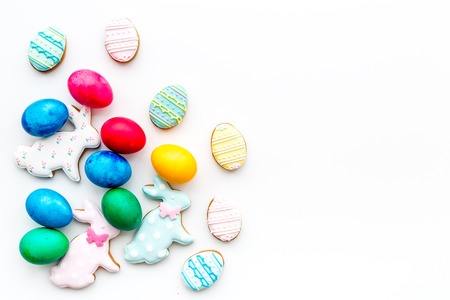 Sweets for celebrate Easter. Gingerbread in shape of easter bunny and easter eggs. White background top view copy space.の写真素材