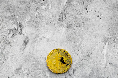 Cryptocurrency physical golden bitcoin coins for changing or selling on stone desk background top view mock upの写真素材
