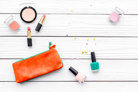 Decorative cosmetics set with beauty bag and nail polish on white desk background top view copy spaceの写真素材