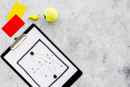 Sport judging concept. Soccer referee. Tactic plan for game, football ball, red and yellow cards, whistle on stone background top view copy spaceの写真素材