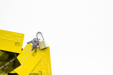 Electronic payments protection. Bank cards near lock and keys on white background top view.の写真素材