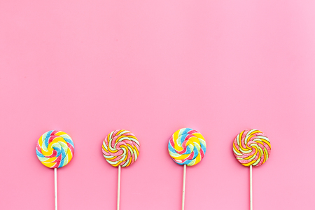 Sweets for party background. Lollipop on pink top view copy space.の写真素材