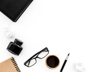 ink, dip pen, notebook, coffee, glasses for writer workplace set on white office background top view mock-upの写真素材