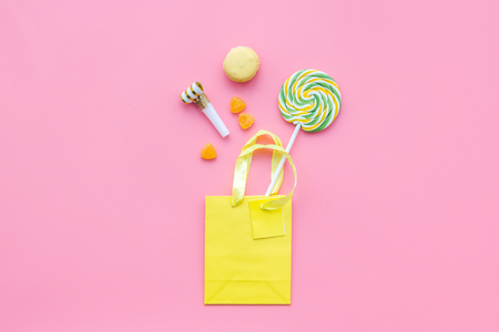 Gift concept. Sweets, paper bag for gift on pink background top view mock upの写真素材