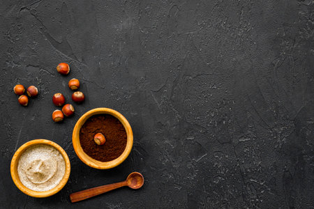 Treatment set with natural hazelnut scrub to take bath on dark background top view mock-upの写真素材