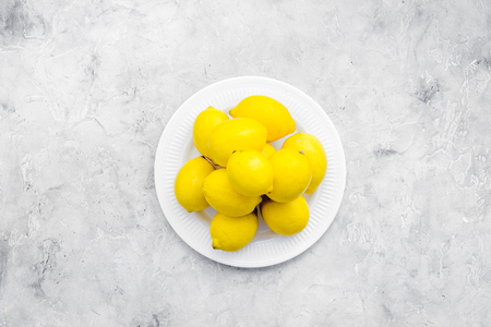 yellow citrus fruit set with lemons stone background top view mock-upの写真素材
