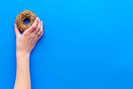 Sweet lunch with glazed donut on blue table background flat lay mockup
