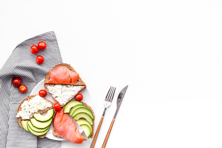 Homemade sandwiches with french baguette, salmon, cheese and vegetable on white kitchen table background top view mock-upの写真素材