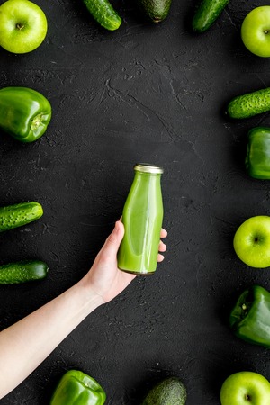 Fitness greeny drink with vegetables on dark desk background top view mock-upの写真素材