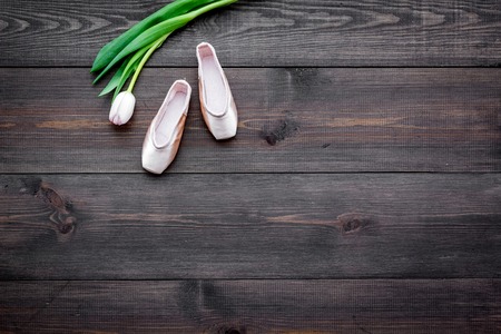 Professional dance shoes. Ballet concept. Pointes on dark wooden background top view.の写真素材